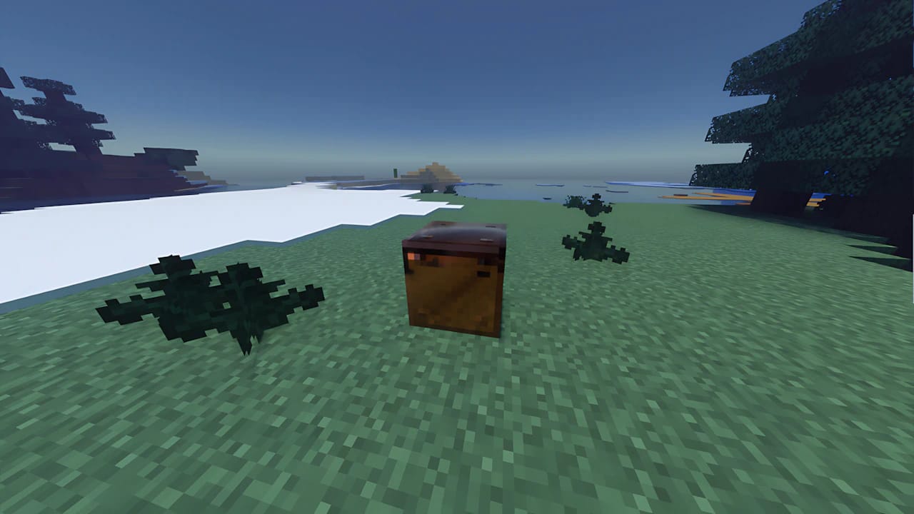 Minecraft Copper Golem mob next to a copper block in a snowy plains biome with high-end ray-traced shaders.