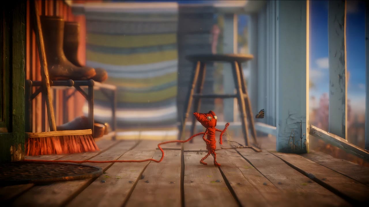 Yarny from Unravel on a porch, demonstrating high-fidelity textures and depth of field in 4K gaming resolution.