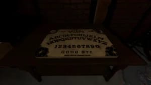 Phasmophobia gameplay screenshot featuring a Ouija board cursed possession on a table with low-light dynamic shadows.