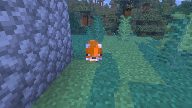 A cute red fox standing on a path next to a cobblestone wall in a Minecraft taiga biome.